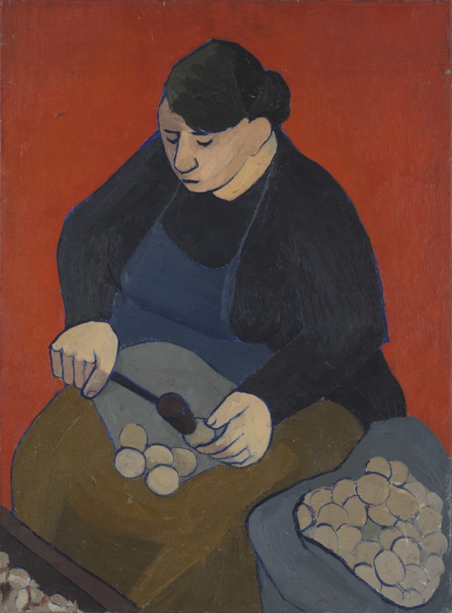 Woman cracking walnuts with a hammer c. 1949